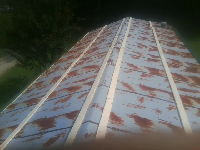 Rusted metal roof panels with new wood purlins before replacement — Storm Damage Roof Repair in Augusta Springs by Roofing Brothers
